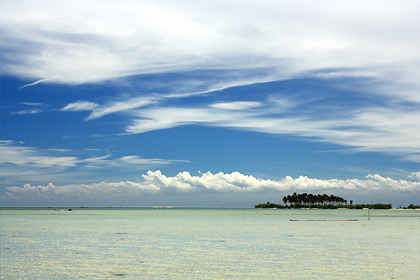 Tondol Beach in Anda, Pangasinan on a partly cloudy day with Tanduyong Island in the right background